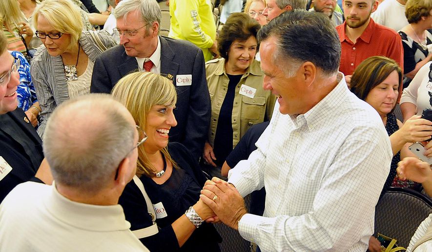 Former Massachusetts Gov. Mitt Romney shakes hands with supporter Mary Jo Pitzer at Tamarack during the Working for Jobs Rally in Beckley, W.Va., Tuesday, Aug. 19, 2014. (AP Photo/Chris Tilley)