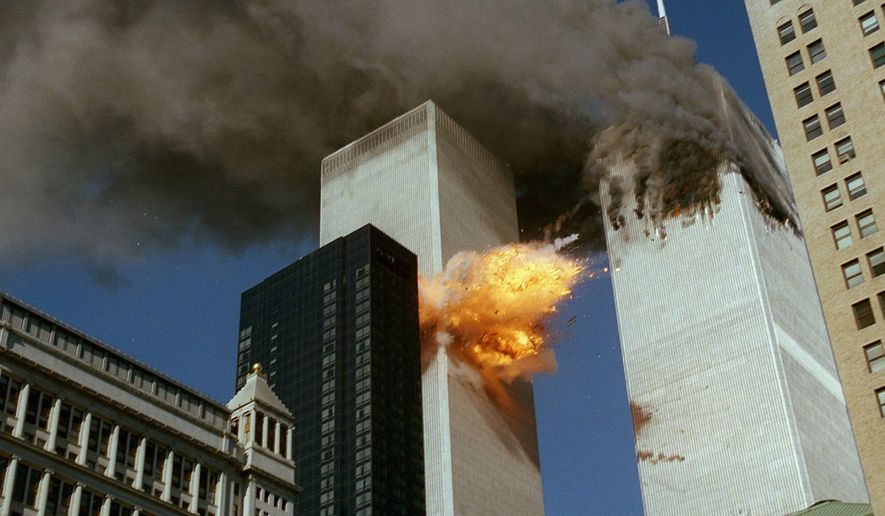 In this Sept. 11, 2001 file photo, United Airlines Flight 175 collides into the south tower of the World Trade Center in New York as smoke billows from the north tower. (AP Photo/Chao Soi Cheong)