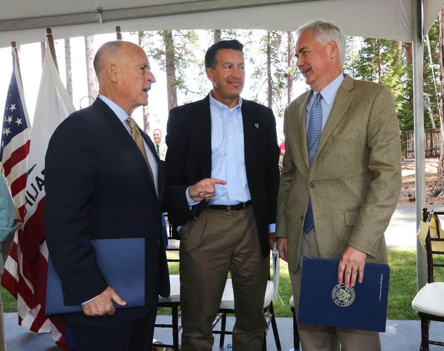 California Gov. Jerry Brown, left, talks with Nevada Gov. Brian Sandoval, center, and Rep. Tom McClintock, R-Calif., after they spoke a the 18th Annual Lake Tahoe Summit, Tuesday, Aug. 19, 2014, in South Lake Tahoe, Calif. McClintock, whose district includes the west side of Lake Tahoe, said that money from logging could help pay for forest improvements. (AP Photo/Rich Pedroncelli)
