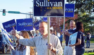 Dan Sullivan, candidate for the Republican candidate for election to the U.S. Senate, waves signs along a busy street on the morning of Alaska&#39;s primary election Tuesday, Aug. 19, 2014, in Anchorage, Alaska. (AP Photo/Becky Bohrer)