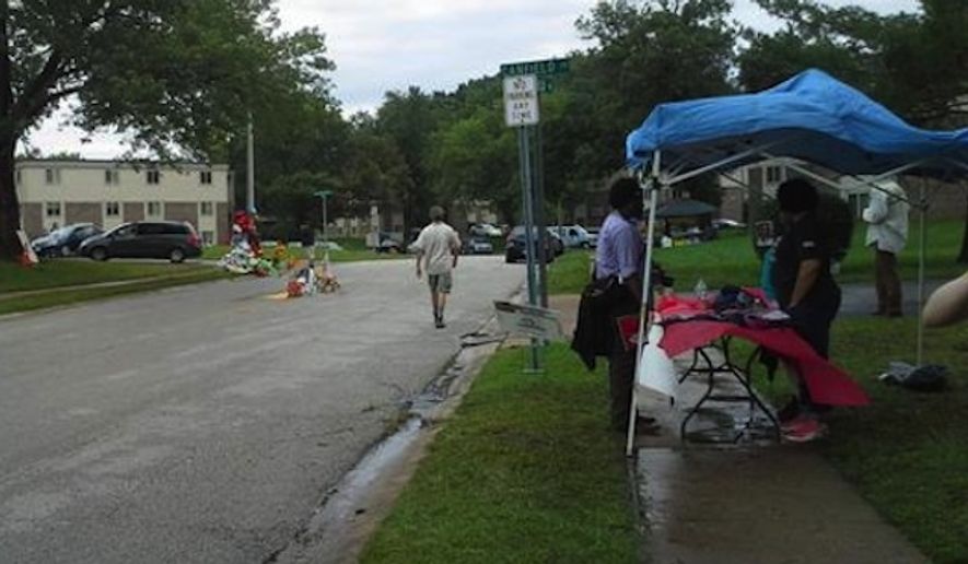 Liberal activists — including from the George Soros-funded Center for Constitutional Rights — have set up voter registration booths at several locations around the St. Louis suburb of Ferguson, including at a makeshift memorial for 18-year-old Michael Brown, who was fatally shot by police Officer Darren Wilson during an altercation on Aug. 9. (Twitter/Jessica Lee)