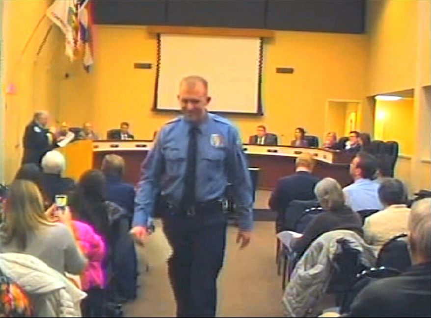 In this  Feb. 11, 2014 image from video released by the City of Ferguson, Mo., officer Darren Wilson attends a city council meeting in Ferguson.  Police identified Wilson, 28,  as the police officer who shot Michael Brown on Aug. 9, 2014, sparking over a week of protests in the suburban St. Louis town.  (AP Photo/City of Ferguson) 