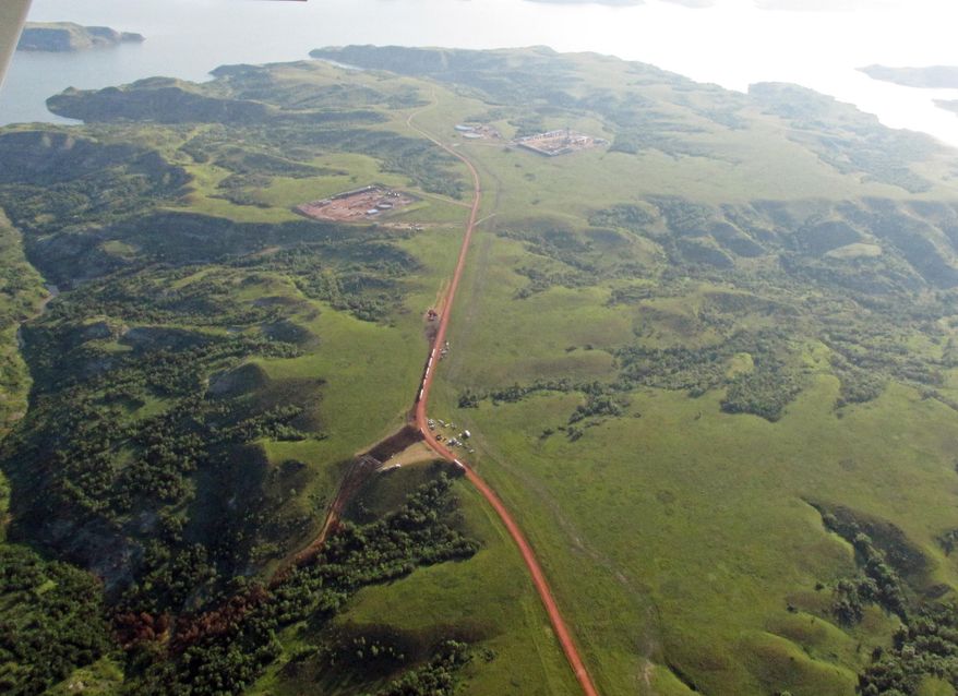 This July 15, 2014 aerial photo shows discolored vegetation, lower left, leading from a pipeline where an estimated 1 million gallons of saltwater spilled from an underground pipeline at Bear Den Bay along the Missouri River near Mandaree, N.D. The environmental director of an American Indian tribe said he’s been shut out of the tribe’s response to a massive saltwater spill on its North Dakota reservation, and criticized leaders for leaving the public “in the absolute dark” on its severity. (AP Photo/Sarah Christianson)