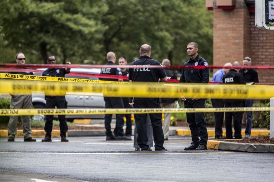 Kent police work at the scene of the double homicide at Wendy's in Kent, Wa.,, Wednesday, Aug. 20, 2014. Police are looking for a car that fled a Kent gas station after two men were fatally shot in an argument over blocking access to a pump. (AP Photo/The Seattle Times, Steve Ringman) OUTS: SEATTLE OUT, USA TODAY OUT, MAGAZINES OUT, TELEVISION OUT, SALES OUT. MANDATORY CREDIT TO: STEVE RINGMAN / THE SEATTLE TIMES.