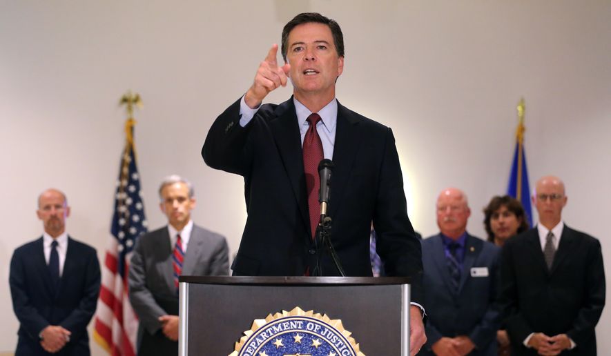 FBI Director James Comey takes a question during a news conference at the FBI field office in Denver, Wednesday Aug. 20, 2014. FBI Director James Comey says Islamic State extremists who executed journalist James Foley are &quot;savages&quot; and that the agency is helping investigate the killing.  (AP Photo/Brennan Linsley)
