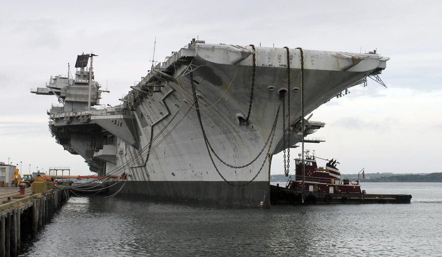 In this photo released by the U.S. Navy, a tug works alongside the decommissioned aircraft carrier USS Saratoga at Naval Station Newport Thursday, Aug. 21, 2014 in Newport, R.I. The ship departed port Thursday for it's final journey to the Esco Marine ship recycling plant in Brownsville, Texas, where it will be scrapped. (AP Photo/U.S. Navy)