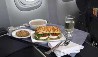 This product image provided by United Airlines shows a Caprese on Asiago Baguette sandwich, one of a variety of the airline&#39;s new first class food options.  The Chicago-based airline on Thursday, Aug. 21, 2014 announced that it’s upgrading first class food options and replacing snacks with full meals on some of its shortest flights. (AP Photo/United Airlines)