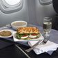 This product image provided by United Airlines shows a Caprese on Asiago Baguette sandwich, one of a variety of the airline&#39;s new first class food options.  The Chicago-based airline on Thursday, Aug. 21, 2014 announced that it’s upgrading first class food options and replacing snacks with full meals on some of its shortest flights. (AP Photo/United Airlines)