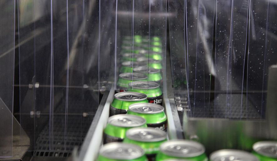 In this photo taken on July 22, 2104, Red Hare Brewing Company beer cans move down the production line at the microbrewery's canning facility in Marietta, Ga. (AP Photo/Johnny Clark) **FILE**