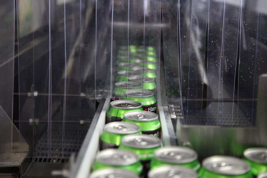 In this photo taken on July 22, 2104, Red Hare Brewing Company beer cans move down the production line at the microbrewery's canning facility in Marietta, Ga. (AP Photo/Johnny Clark) **FILE**