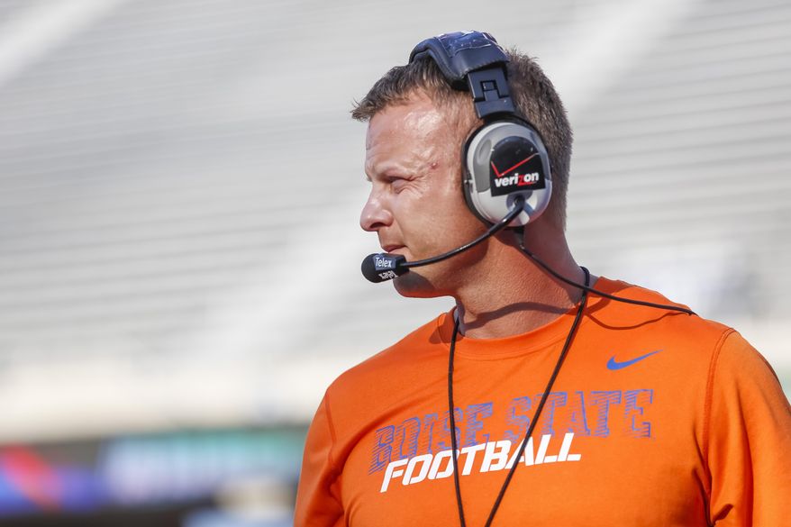 FILE - In this Aug. 15, 2014, file photo, Boise State head coach Bryan Harsin watches the action during the NCAA college football team's scrimmage in Boise, Idaho. Harsin is back at Boise State, after Chris Petersen left for Washington. His task now is to figure out how to keep the Broncos relevant on the national scene. (AP Photo/Otto Kitsinger, File)
