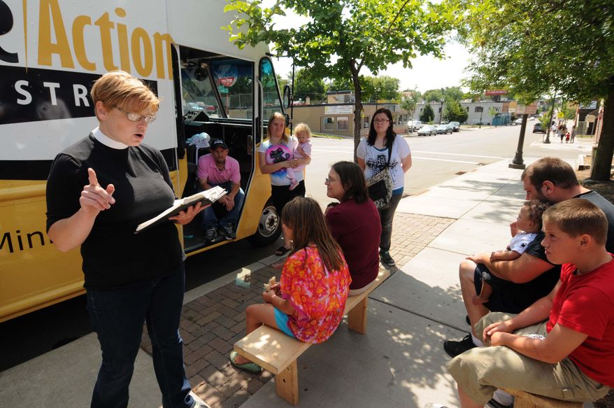 ADVANCED FOR RELEASE SATURDAY, AUGUST 23, 2014 Pastor Margaret Kelly runs a food truck ministry she calls "Shobi's Table" where she serving free calzones she makes from scratch and reads some Bible verses to those assembled on the sidewalk on Payne Avenue in St. Paul, on Thursday, August 14, 2014. (AP Photo/Pioneer Press, Scott Takushi)