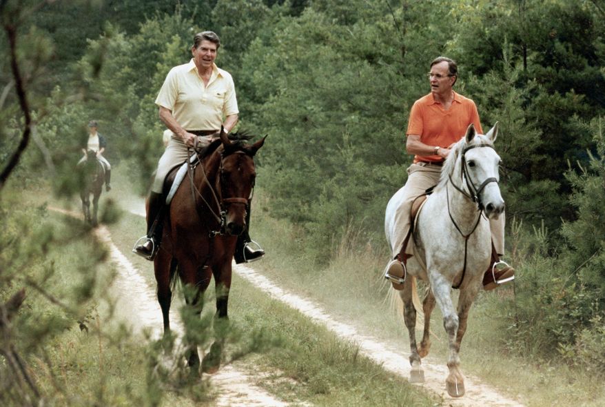 In this photo released by the White House, U.S. President Ronald Reagan, left, and Vice President George Bush go horseback riding at Camp David, Md., July 1981.  (AP Photo/White House, Michael Evans)