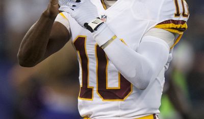 Washington Redskins&#39; quarterback Robert Griffin III calls a timeout during the first quarter against the Baltimore Ravens during the first quarter of their pre-season game at M&amp;T Bank Stadium on August 23, 2014 in Baltimore, Maryland. (Pete Marovich Special to The Washington Times)