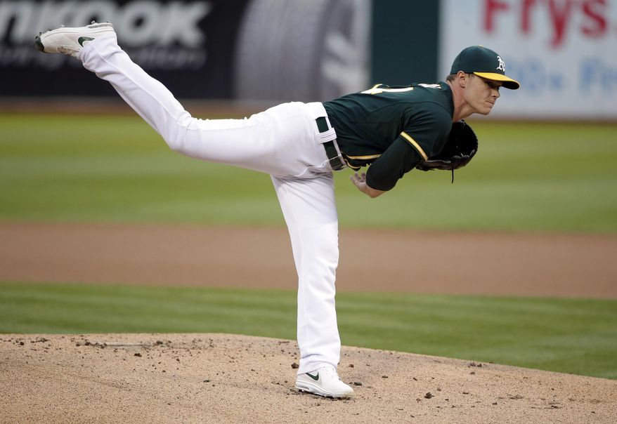 Oakland Athletics starting pitcher Sonny Gray throws to the Los Angeles Angels during the first inning of a baseball game on Friday, Aug. 22, 2014, in Oakland, Calif. (AP Photo/Marcio Jose Sanchez)