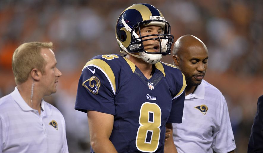 St. Louis Rams quarterback Sam Bradford (8) leaves the field after getting hit by Cleveland Browns defensive end Armonty Bryant in the first quarter of a preseason NFL football game Saturday, Aug. 23, 2014, in Cleveland. (AP Photo/David Richard)