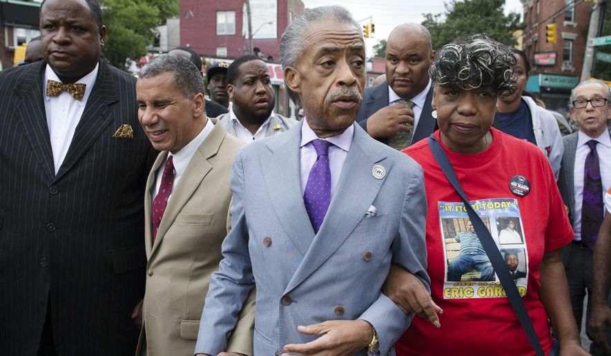 The Rev. Al Sharpton, second from right, walks with former New York Gov. David Paterson, second from left, and Gwen Carr, right, mother of Eric Garner, as they arrive before a march to protest the death of Eric Garner, Saturday, Aug. 23, 2014, in the Staten Island borough of New York. The afternoon rally and march was led by Sharpton and relatives of Garner, who died July 17 after a New York Police Department officer took him to the ground with a banned tactic in a confrontation captured on video. (AP Photo/John Minchillo) **FILE**