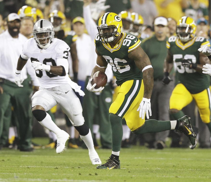 Green Bay Packers' Mike Neal runs with the ball after recovering a fumble during the first half of an NFL preseason football game against the Oakland Raiders Friday, Aug. 22, 2014, in Green Bay, Wis. (AP Photo/Tom Lynn)