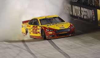 Joey Logano celebrates his win in a NASCAR Sprint Cup Series auto race at Bristol Motor Speedway on Saturday, Aug. 23, 2014, in Bristol, Tenn. (AP Photo/The Bristol Herald-Courier, Andre Teague) 