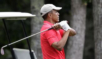 President Barack Obama follows through on a swing while golfing at Farm Neck Golf Club, in Oak Bluffs, Mass., on the island of Martha&#39;s Vineyard, Saturday, Aug. 23, 2014. Obama is vacationing on the island. (AP Photo/Steven Senne)