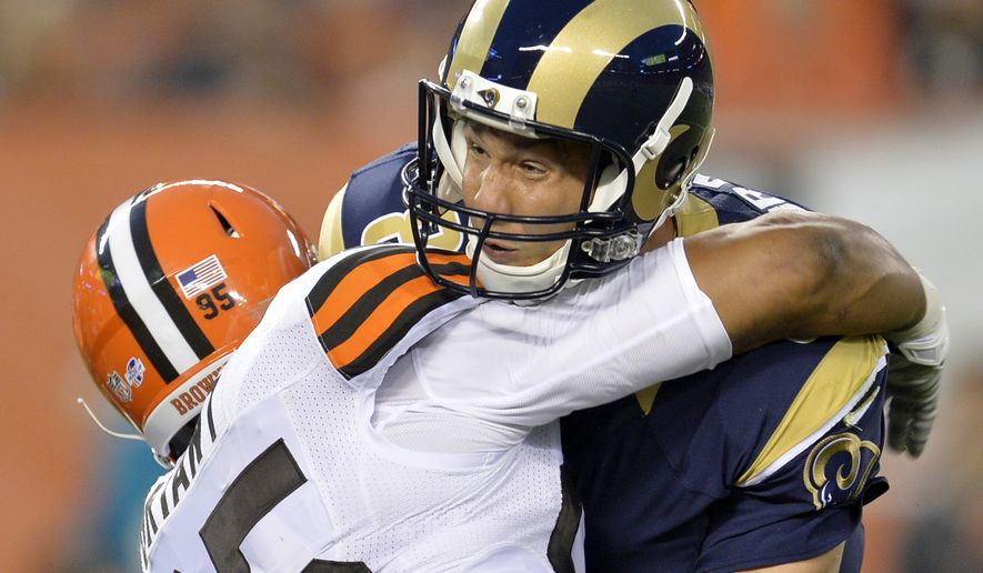 St. Louis Rams quarterback Sam Bradford is hit by Cleveland Browns defensive end Armonty Bryant (95) in the first quarter of a preseason NFL football game Saturday, Aug. 23, 2014, in Cleveland. Bradford left the game and was taken to the locker room after the play. (AP Photo/David Richard)
