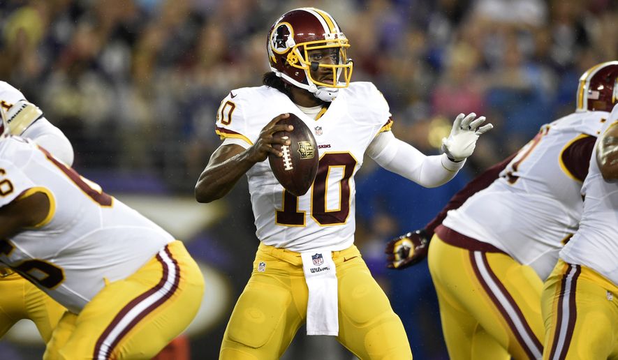 Washington Redskins quarterback Robert Griffin III looks for a receiver in the first half of an NFL preseason football game against the Baltimore Ravens, Saturday, Aug. 23, 2014, in Baltimore. (AP Photo/Nick Wass)