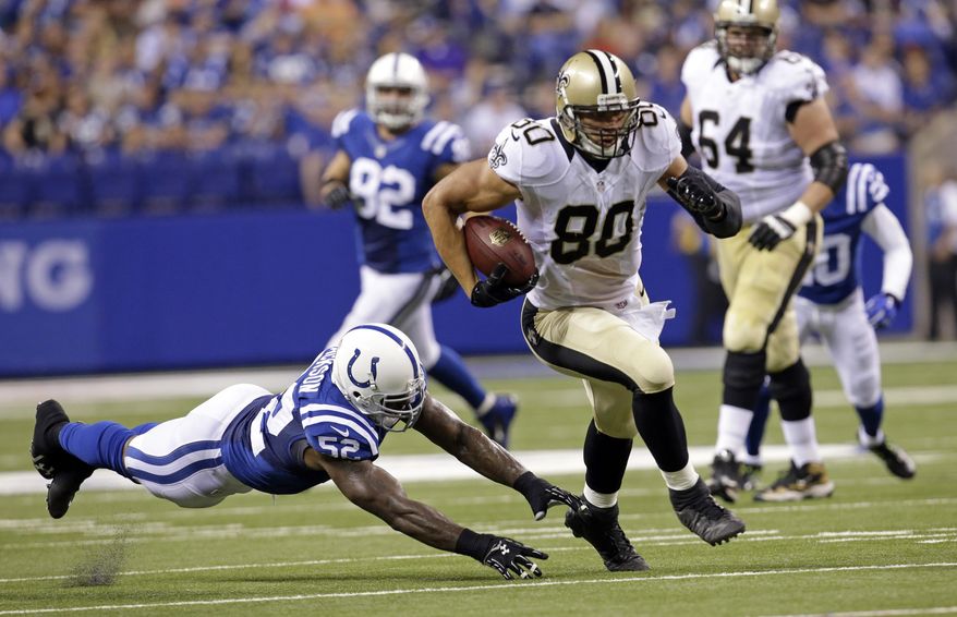 New Orleans Saints tight end Jimmy Graham (80) out runs the tackle of Indianapolis Colts inside linebacker D'Qwell Jackson during the first half of an NFL preseason football game in Indianapolis, Saturday, Aug. 23, 2014. (AP Photo/AJ Mast)