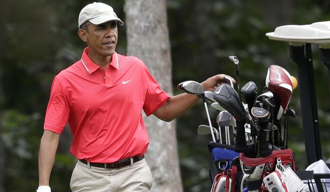 President Barack Obama selects a club while golfing at Farm Neck Golf Club, in Oak Bluffs, Mass., on the island of Martha&#x27;s Vineyard, Saturday, Aug. 23, 2014. Obama is vacationing on the island. (AP Photo/Steven Senne)
