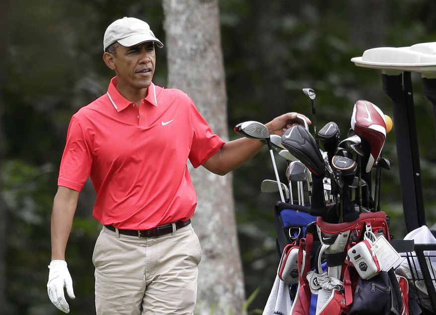 President Barack Obama selects a club while golfing at Farm Neck Golf Club, in Oak Bluffs, Mass., on the island of Martha&#39;s Vineyard, Saturday, Aug. 23, 2014. Obama is vacationing on the island. (AP Photo/Steven Senne)