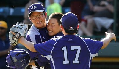 South Korea&#39;s Hae Chan Choi, left, celebrates with catcher Sang Hoon Han, center, and Shane Jaemin Kim (17) after getting the final out of a 8-4 win in the Little League World Series championship baseball game against Chicago in South Williamsport, Pa., Sunday, Aug. 24, 2014. (AP Photo/Gene J. Puskar)