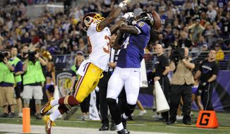 Washington Redskins free safety David Amerson, left, breaks up a pass attempt to Baltimore Ravens wide receiver Marlon Brown in the end zone in the first half of an NFL preseason football game, Saturday, Aug. 23, 2014, in Baltimore. (AP Photo/Nick Wass)