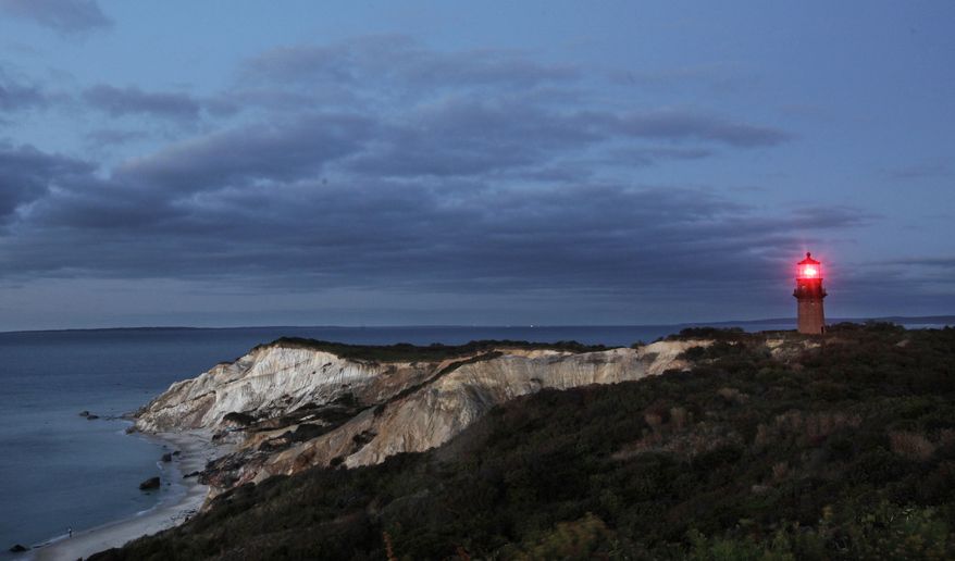 Gay Head Light flashes a red signal in Aquinnah, Mass., on the western tip of the island of Martha's Vineyard. Leaders of the Aquinnah Wampanoags, the federally recognized American Indian tribe whose ancestors inhabited the land, have proposed transforming an unfinished tribal community center a few miles inland into a high-stakes bingo and poker hall filled with electronic betting machines. But not all visitors and residents are convinced the tribe’s proposal fits with the character of the resort island. (AP Photo/Mark Lennihan/File)