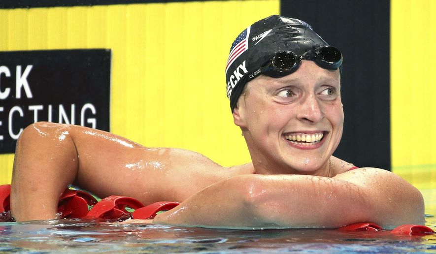 Katie Ledecky of the U.S. smiles after she set a new world record in her women&#39;s 1500m freestyle final at the Pan Pacific swimming championships in Gold Coast, Australia, Sunday, Aug. 24, 2014. Ledecky won the race setting a new world record of 15 minutes, 28.36 seconds.(AP Photo/Rick Rycroft)