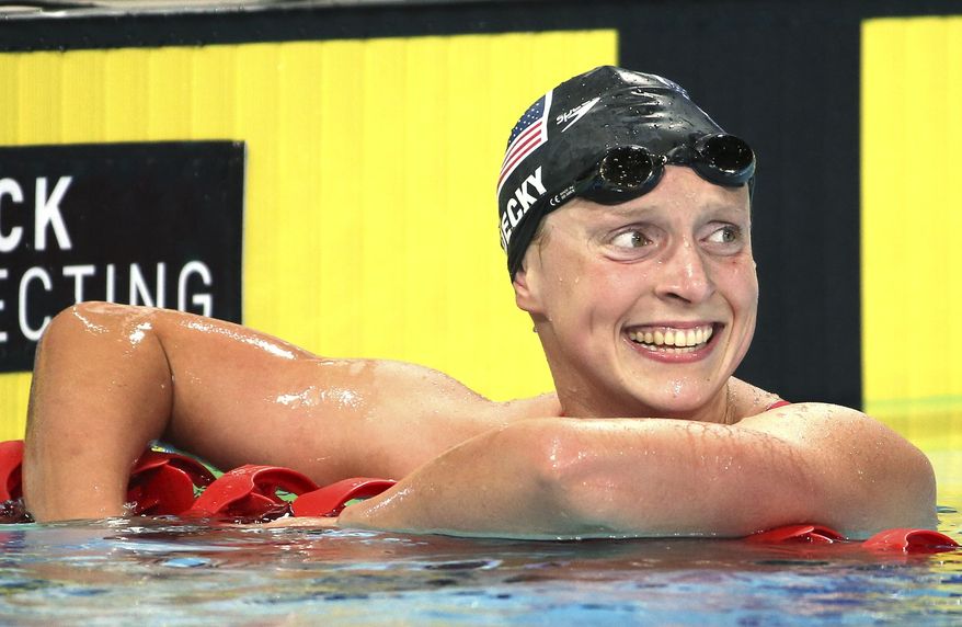 Katie Ledecky of the U.S. smiles after she set a new world record in her women&#39;s 1500m freestyle final at the Pan Pacific swimming championships in Gold Coast, Australia, Sunday, Aug. 24, 2014. Ledecky won the race setting a new world record of 15 minutes, 28.36 seconds.(AP Photo/Rick Rycroft)