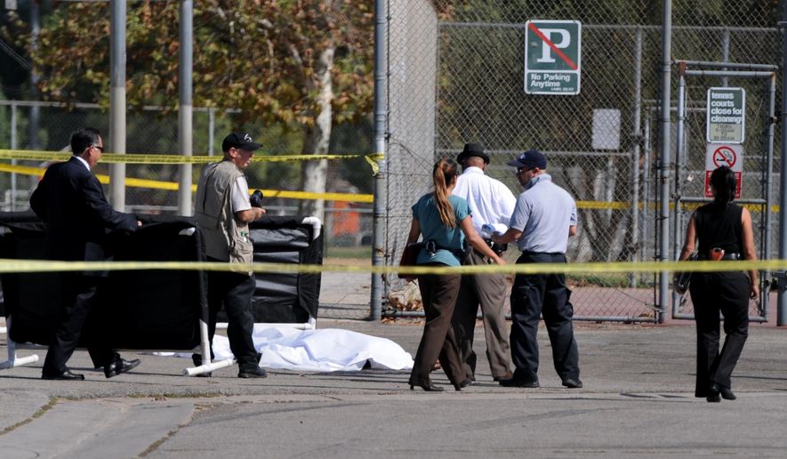 Los Angeles Police Department officers investigate the scene of a shooting Sunday, Aug. 24, 2014, where one person was killed near the 14400 block of Polk Street in Sylmar, Calif.  Describing what they called “a major public threat,” Los Angeles police said they are seeking clues to three separate shootings in the Northeast San Fernando Valley that left three people dead and four others injured early Sunday morning and appear to be connected. A suspect in the shootings was taken into custody by SWAT officers Sunday night after holing up inside a house in the Sylmar neighborhood for about an hour, Capt. William Hayes said.  (AP Photo/Los Angeles Daily News, Dean Musgrove)