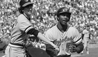 FILE - In this Oct. 5, 1974, photo, Baltimore Orioles&#x27; Paul Blair is greeted at the plate after a home run in the opening game against the Oakland Athletics in the American League baseball playoffs in Oakland, Calif. Blair, the eight-time Gold Glove center fielder who helped the Orioles win World Series titles in 1966 and 1970, died Thursday night, Dec. 26, 2013, at Sinai Hospital of Baltimore. (AP Photo)