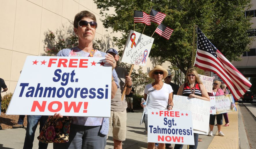 Bonnie McAdams joins others calling for the release of Marine Andrew Tahmooressi who was detained by the Mexican government  for crossing the border with weapons, during a rally outside the Stanford Mansion where Mexican President Enrique Pena Nieto  will appear with Gov. Jerry Brown, in Sacramento, Calif., Tuesday, Aug. 26, 2014.(AP Photo/Rich Pedroncelli)