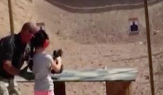 In this Aug. 25, 2014 image made from video provided by the Mohave County Sheriff Department, firing-range instructor Charles Vacca, left, shows a 9-year old girl how to use an Uzi. Vacca, 39, was standing next to the girl on Monday at the Last Stop range in Arizona, south of Las Vegas, when the girl squeezed the trigger, causing the Uzi to recoil upward and shoot Vacca in the head. (AP Photo/Mohave County Sheriff Department)