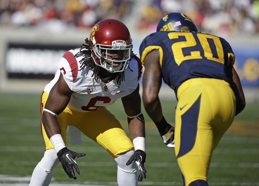 FILE - In this Nov. 9, 2013, file photo, Southern California cornerback Josh Shaw, left, lines up against California defensive back Isaac Lapite during the first quarter of an NCAA college football game in Berkeley, Calif. Shaw injured both ankles after leaping from a second-story balcony to save his 7-year-old nephew, Carter, from drowning in a pool. Shaw was named a team captain on Saturday, Aug. 23, 2014, and later that night was attending a family function at a cousin's apartment in his hometown of Palmdale when he saw his nephew, who can't swim, struggling in the pool. (AP Photo/Eric Risberg, File)