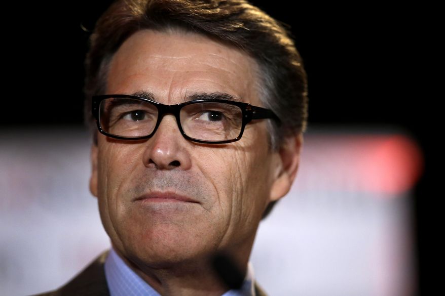 In this Aug. 8, 2014 photo Governor Rick Perry pauses as he addresses attendees at the 2014 Red State convention in Fort Worth, Texas. Two Texans, one White House. Is the 2016 Republican campaign trail big enough? After plummeting from a front-runner to political punchline three years ago, Governor Perry appears poised to run again _ hoping to convince conservatives he can better cope with the national spotlight. (AP Photo/Tony Gutierrez)