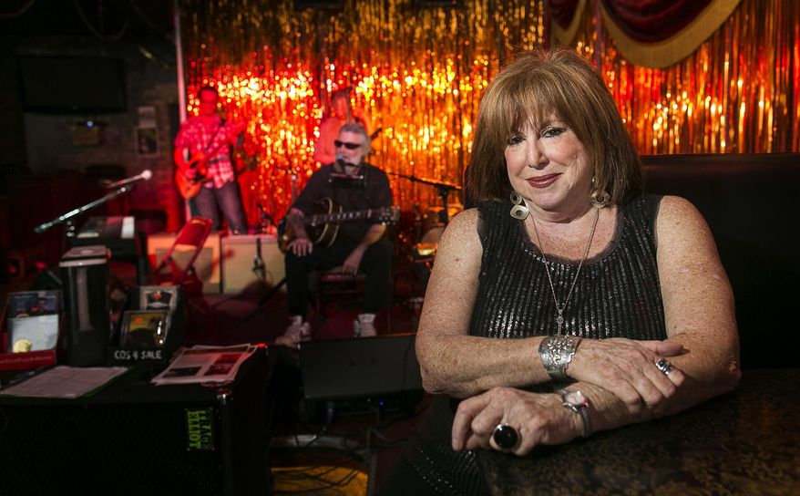 ADVANCE FOR WEEKEND EDITIONS, AUG. 30-31 - In this photo taken on Aug. 14, 2014, Nancy Coplin, poses for a portrait as blues musician, Paul Oscher, left, performs at C-Boy's Heart & Soul in the SOCO District of Austin, Texas. (AP Photo/Austin American-Statesman, Rodolfo Gonzalez) AUSTIN CHRONICLE OUT, COMMUNITY IMPACT OUT, INTERNET AND TV MUST CREDIT PHOTOGRAPHER AND STATESMAN.COM, MAGS OUT