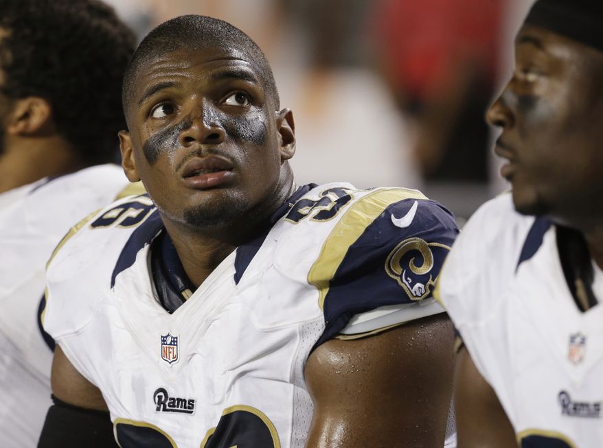 St. Louis Rams defensive end Michael Sam (96) looks up at the scoreboard from the sidelines during the first half of an NFL preseason football game against the Miami Dolphins, Thursday, Aug. 28, 2014 in Miami Gardens, Fla. The Dolphins defeated the Rams 14-13. (AP Photo/Lynne Sladky)