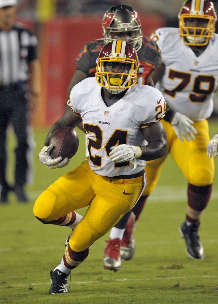 Washington Redskins running back Silas Redd (24) heads up field after getting past the Tampa Bay Buccaneers defense during the second quarter of an NFL preseason football game Thursday, Aug. 28, 2014, in Tampa, Fla. (AP Photo/Steve Nesius)