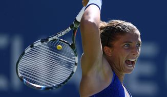 Sara Errani, of Italy, follows through on a shot against Venus Williams, of the United States, during the third round of the 2014 U.S. Open tennis tournament, Friday, Aug. 29, 2014, in New York. (AP Photo/Matt Rourke)
