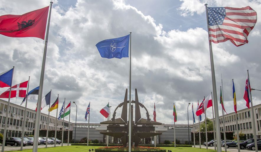 Flags of member nations flap in the wind outside NATO headquarters in Brussels on Friday, Aug. 29, 2014. NATO on Friday urged Russia to cease its military actions and take immediate and verifiable steps towards de-escalation of the crisis in Ukraine. (AP Photo/Olivier Matthys)