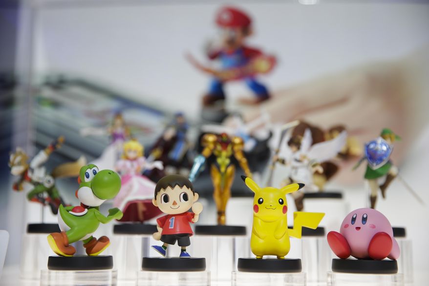 In this June 10, 2014 file photo, amiibo characters for Wii U are on display at the Nintendo booth during the Electronic Entertainment Expo, in Los Angeles. Pikachu and Link will be among the first characters coming to "amiibo." Nintendo announced the 12 characters on Friday, Aug. 29, 2014, that will be part of its upcoming toys-meet-game franchise set for release later this year. (AP Photo/Jae C. Hong, File)