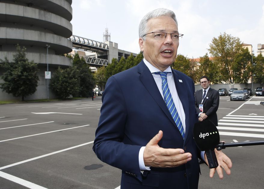 Belgian Foreign Minister Didier Reynders answers reporters' questions as he arrives for an informal meeting of the EU Foreign Affairs Ministers, in Milan, Italy, Friday, Aug. 29, 2014. European Union foreign ministers on Friday were set to weigh adopting a tougher stance on the Ukraine crisis amid increasing calls to beef up economic sanctions against Russia. (AP Photo/Luca Bruno)