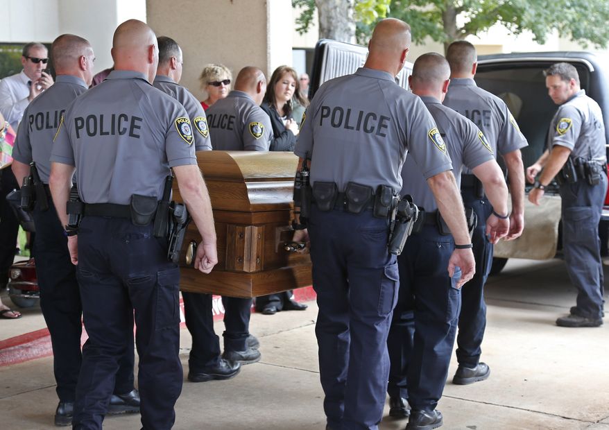 The casket of Oklahoma City canine officer K-9 Kye, is carried into a waiting hearse following funeral services for the dog in Oklahoma City, Thursday, Aug. 28, 2014. K-9 Kye died Aug. 25 after being stabbed by a burglary suspect on Aug. 24. (AP Photo/Sue Ogrocki)