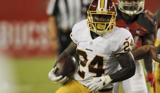 Washington Redskins running back Silas Redd (24) carries the ball against the Tampa Bay Buccaneers during a NFL preseason football game Thursday, Aug. 28, 2014 in Tampa, Fla. (AP Photo/Steve Nesius) 