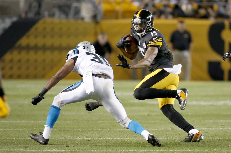 Pittsburgh Steelers wide receiver Justin Brown (15) tries to evade Carolina Panthers defensive back James Dockery (31) in the second quarter of a NFL preseason football game on Thursday, Aug. 28, 2014 in Pittsburgh. (AP Photo/Gene Puskar)